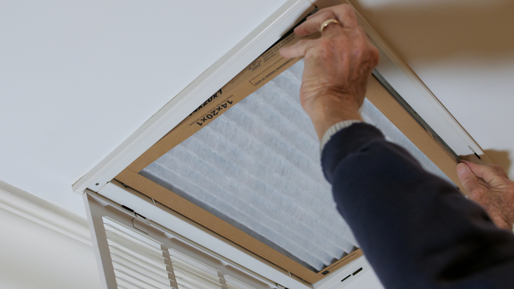 Man,replacing,dirty,hvac,air,filter,in,ceiling,vent.,home